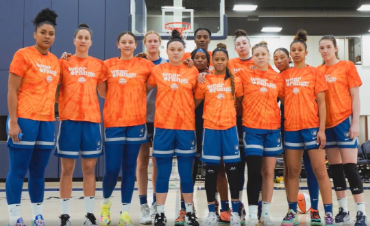 Girls Basketball Team wearing Orange shirts. In support of stopping gun violence 
